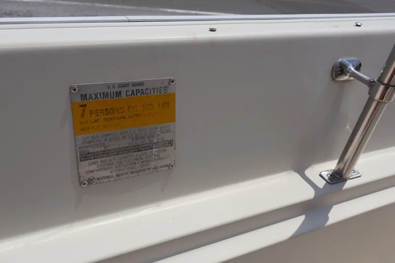 Slide: The Image of 1991 Boston Whaler 170 Montauk capacity plate showing maximum load and passenger limits. - 13