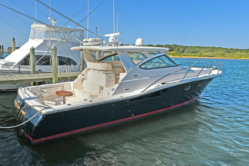 Slide: The Image of 2008 Tiara Yachts 4200 Open docked in a serene marina setting. - 1