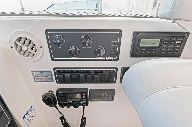 Slide: The Image of Control panel of a 2008 Tiara Yachts 4200 Open, featuring gauges and communication equipment. - 25