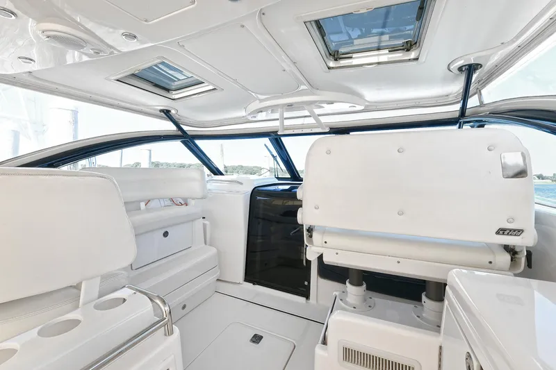 Slide: The Image of 2008 Tiara Yachts 4200 Open interior with white seating and skylights. - 17