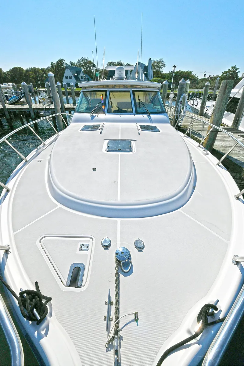 Slide: The Image of 2008 Tiara Yachts 4200 Open docked, showcasing spacious deck and sleek design. - 13