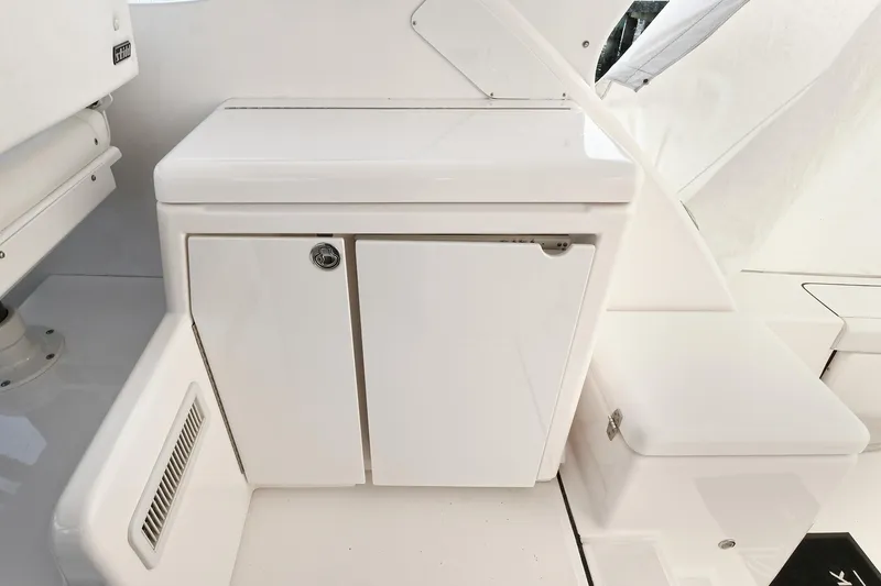 Slide: The Image of 2008 Tiara Yachts 4200 Open interior, featuring sleek white cabinetry and seating. - 18