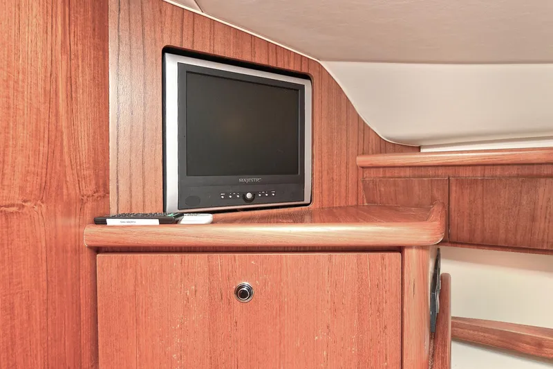 Slide: The Image of 2008 Tiara Yachts 4200 Open interior with TV and wooden cabinetry. - 42