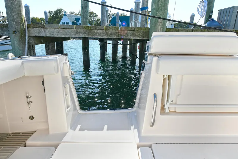 Slide: The Image of 2008 Tiara Yachts 4200 Open, docked, showcasing rear deck and water view. - 10
