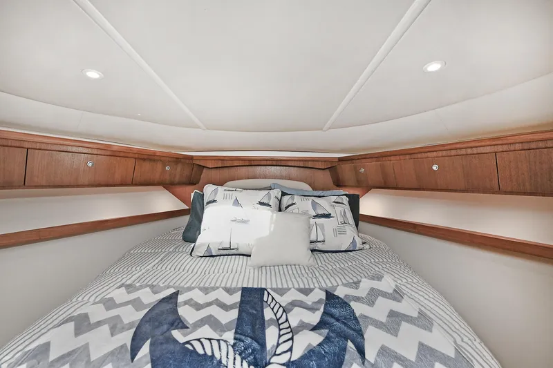 Slide: The Image of Luxurious cabin interior of 2008 Tiara Yachts 4200 Open with nautical-themed bedding. - 40