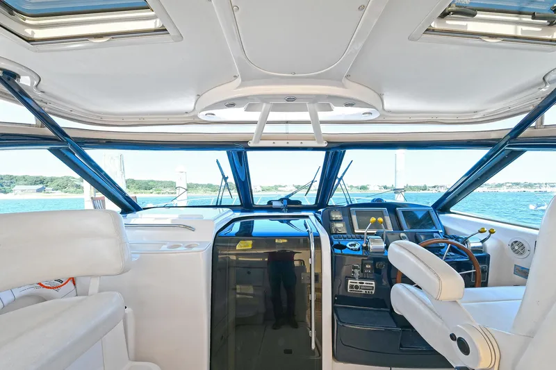 Slide: The Image of 2008 Tiara Yachts 4200 Open helm with modern controls and panoramic windows. - 21