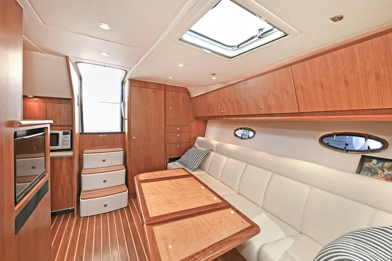 Slide: The Image of Luxurious interior of 2008 Tiara Yachts 4200 Open, featuring elegant wood finishes and comfortable seating. - 28