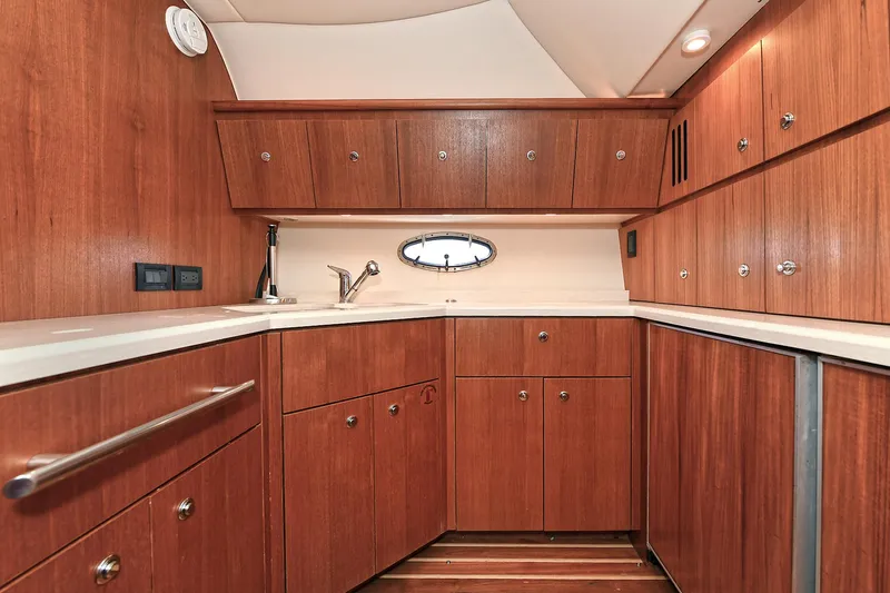 Slide: The Image of Luxurious wooden interior of 2008 Tiara Yachts 4200 Open, featuring ample cabinetry and sleek design. - 30