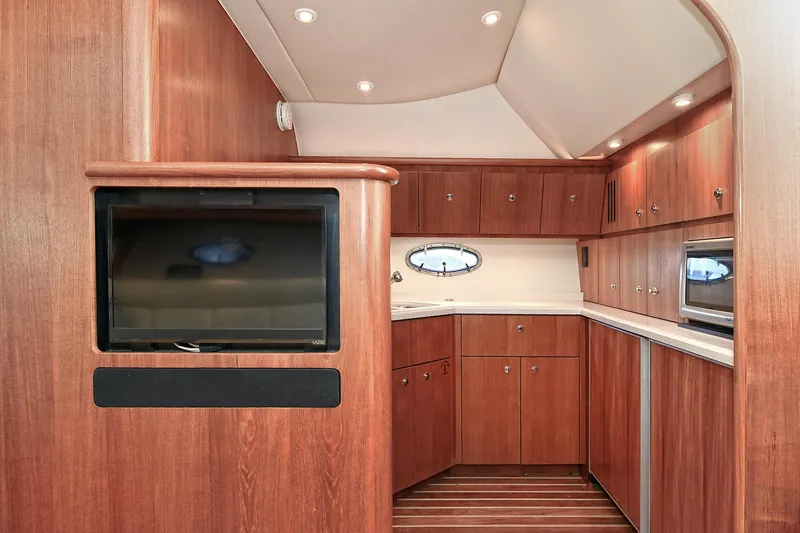 Slide: The Image of 2008 Tiara Yachts 4200 Open interior with wood cabinetry and modern amenities. - 29