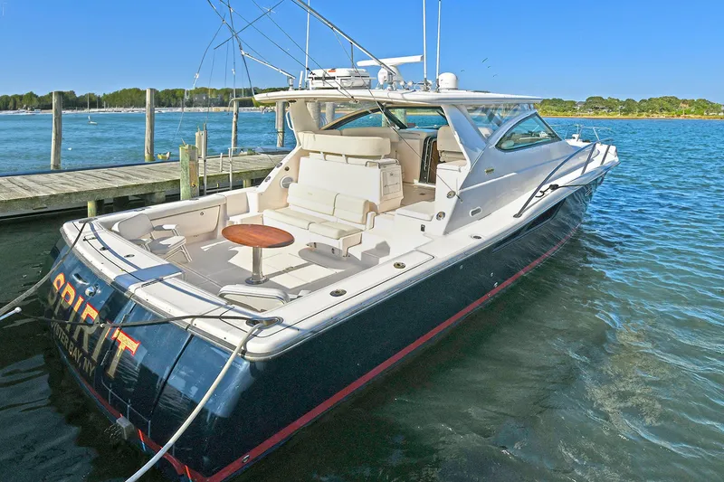Slide: The Image of 2008 Tiara Yachts 4200 Open docked, featuring spacious deck and sleek design. - 2