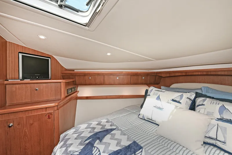 Slide: The Image of 2008 Tiara Yachts 4200 Open cabin with cozy bedding and wooden interior. - 41