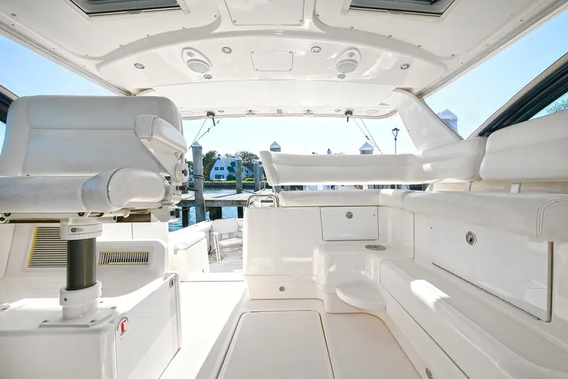 Slide: The Image of 2008 Tiara Yachts 4200 Open interior, featuring sleek white seating and modern design. - 16