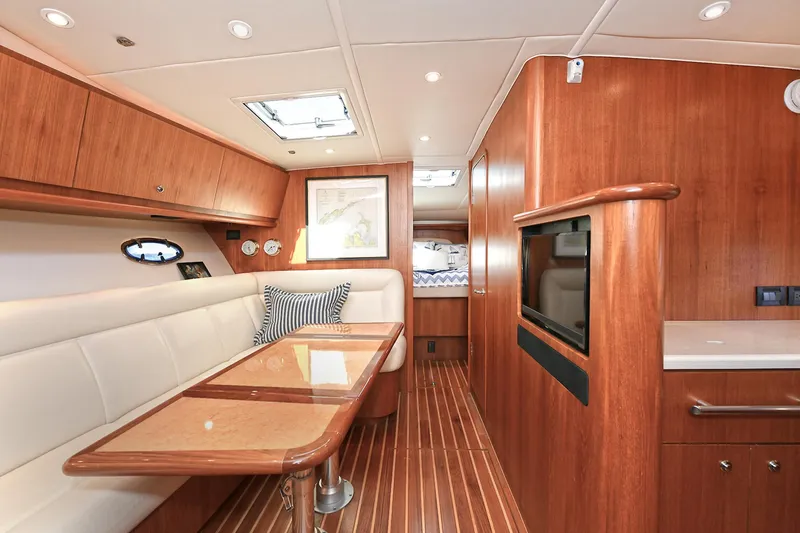 Slide: The Image of 2008 Tiara Yachts 4200 Open interior with wood finish, dining area, and modern amenities. - 35