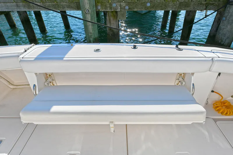 Slide: The Image of 2008 Tiara Yachts 4200 Open, white bench seat, docked by wooden pier. - 9