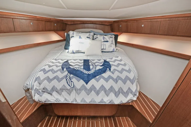 Slide: The Image of Luxurious cabin interior of 2008 Tiara Yachts 4200 Open with nautical-themed bedding. - 39