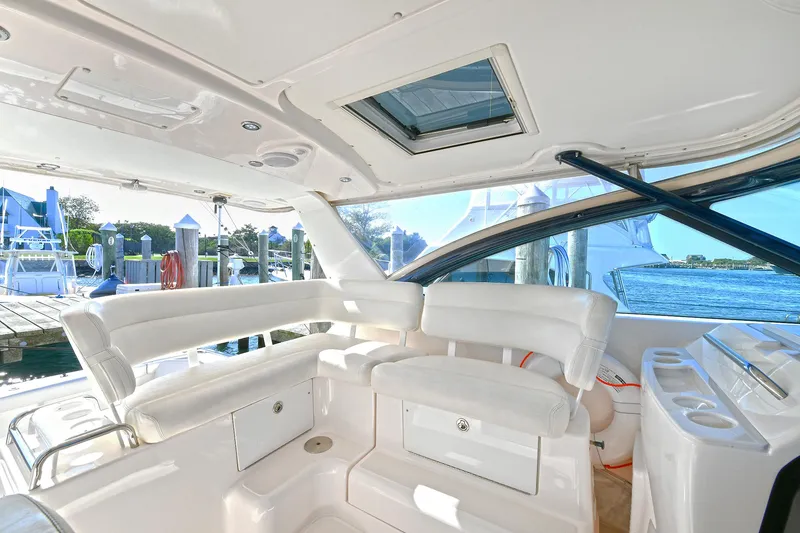 Slide: The Image of 2008 Tiara Yachts 4200 Open interior with white seating and marina view. - 15