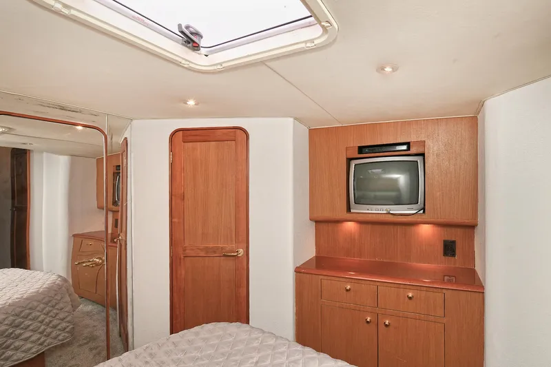 Slide: The Image of Interior of a yacht with wooden furnishings, a TV, and a skylight. - 50