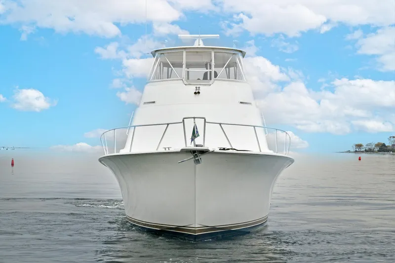 Slide: The Image of Ocean Yachts 52 Super Sport 2001 on calm water under blue sky. - 4