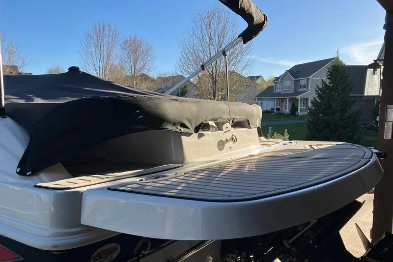 Slide: The Image of 2020 Hurricane SunDeck Sport 188 IO boat with covered deck in residential area. - 5