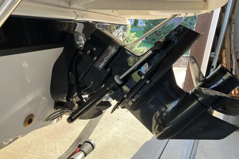Slide: The Image of 2020 Hurricane SunDeck Sport 188 IO boat with MerCruiser engine in a garage setting. - 18