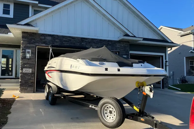 Slide: The Image of 2020 Hurricane SunDeck Sport 188 IO boat on trailer in residential driveway. - 3