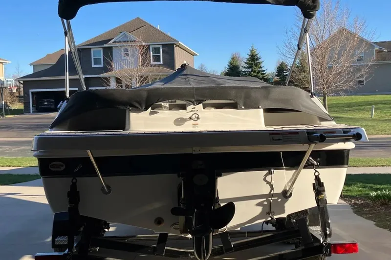 Slide: The Image of 2020 Hurricane SunDeck Sport 188 IO boat parked in a residential driveway. - 2