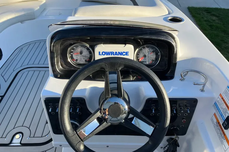 Slide: The Image of 2020 Hurricane SunDeck Sport 188 IO dashboard with steering wheel and Lowrance display. - 9