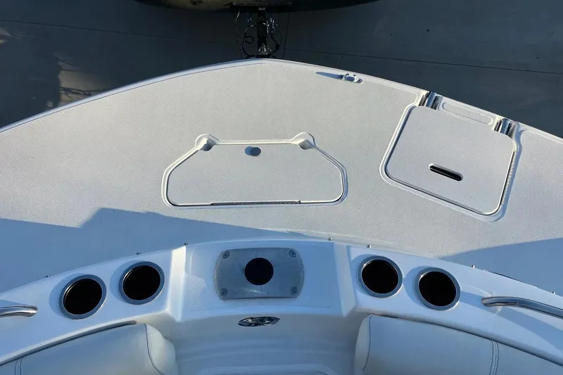 Slide: The Image of 2020 Hurricane SunDeck Sport 188 IO boat deck with cup holders and storage compartments. - 11