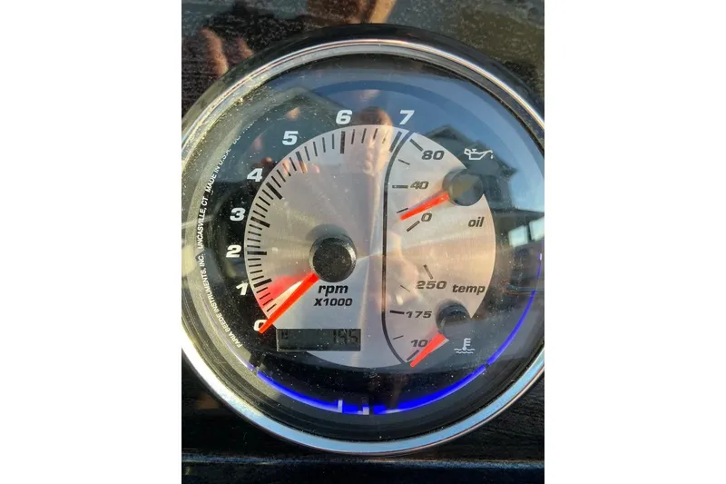 Slide: The Image of Close-up of a 2020 Hurricane SunDeck Sport 188 IO tachometer displaying RPM, oil, and temperature gauges. - 10