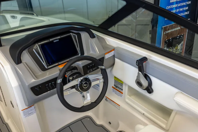 Slide: The Image of 2026 Chaparral 23 SSi OB boat dashboard with steering wheel and control panel. - 14