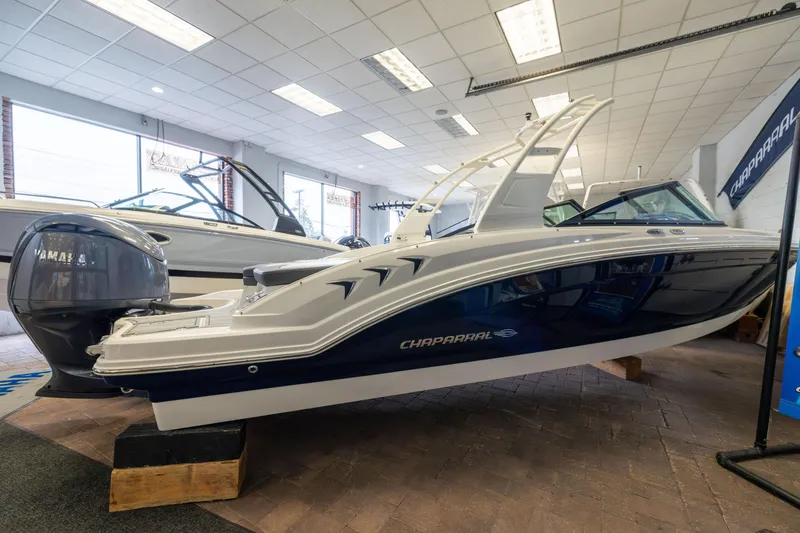Slide: The Image of 2026 Chaparral 23 SSi OB boat displayed indoors with Yamaha outboard engine. - 3