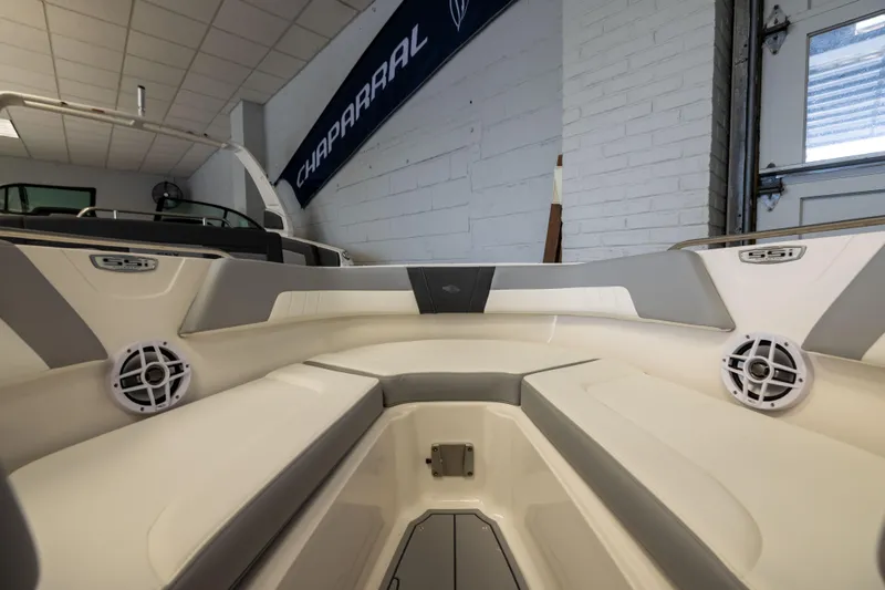 Slide: The Image of 2026 Chaparral 23 SSi OB boat interior with cushioned seating and speakers. - 11