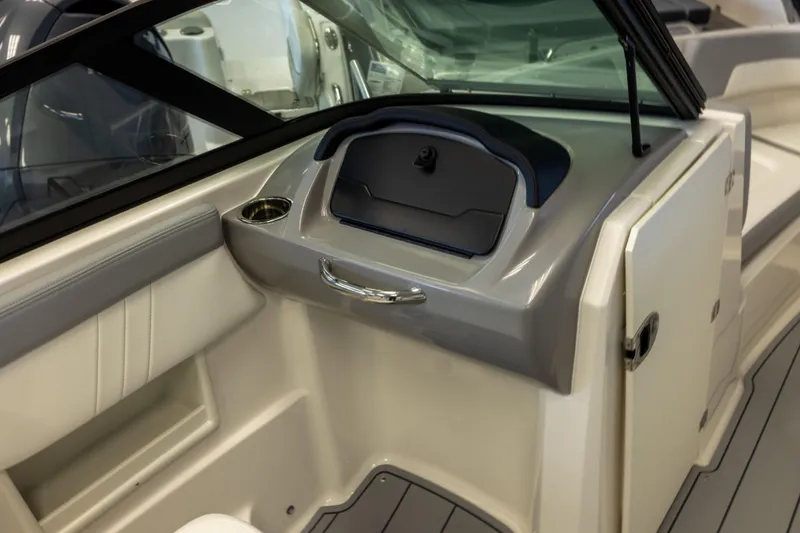 Slide: The Image of Interior view of 2026 Chaparral 23 SSi OB boat, featuring sleek dashboard and seating. - 16