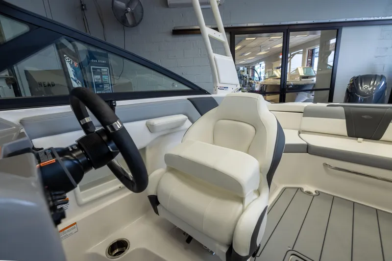 Slide: The Image of Interior of 2026 Chaparral 23 SSi OB boat, featuring sleek seating and modern steering. - 17