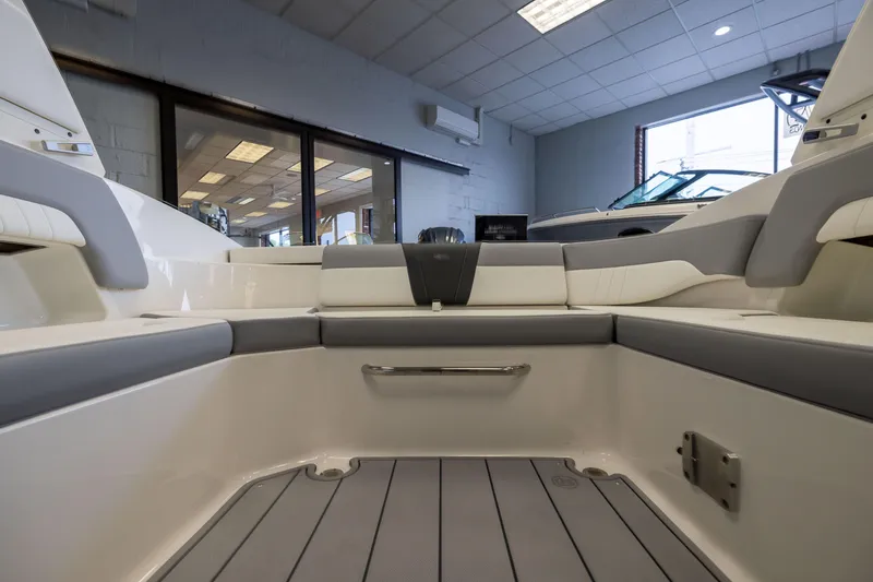 Slide: The Image of Interior view of 2026 Chaparral 23 SSi OB boat, showcasing seating and flooring. - 13