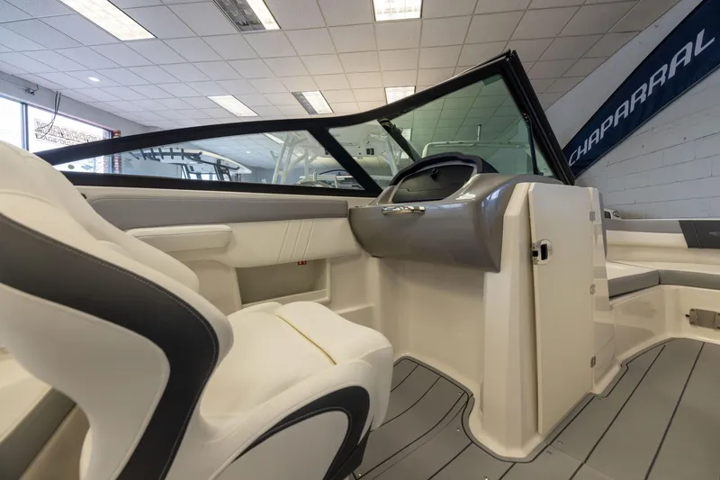 Slide: The Image of Interior view of 2026 Chaparral 23 SSi OB boat, showcasing helm and seating area. - 19