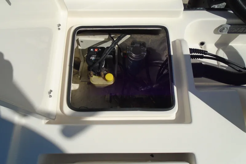 Slide: The Image of Open hatch of 2022 Pathfinder 2200 TRS boat showing internal components and wiring. - 27