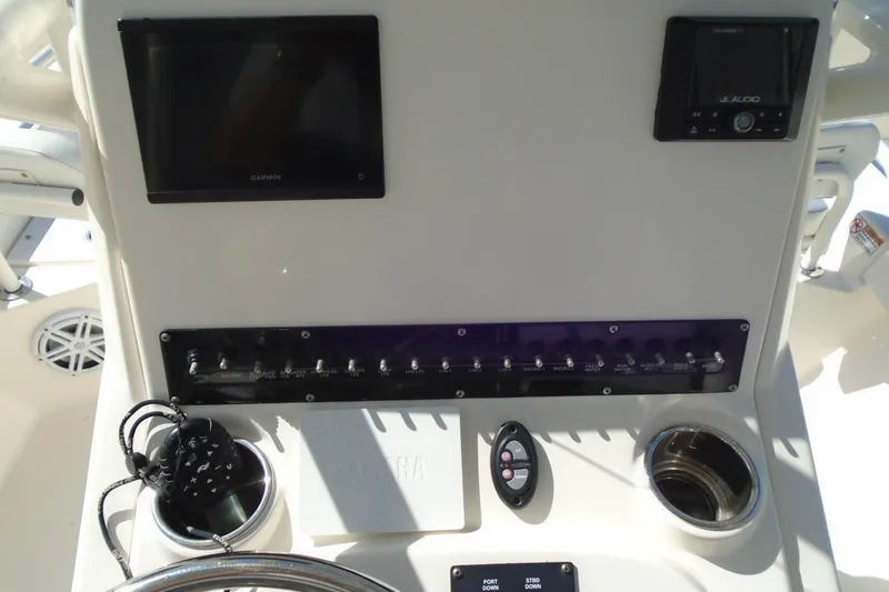 Slide: The Image of Center console of 2022 Pathfinder 2200 TRS boat with Garmin display and controls. - 23