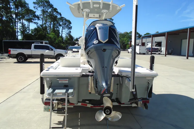 Slide: The Image of 2022 Pathfinder 2200 TRS boat with powerful outboard motor, parked outdoors. - 8
