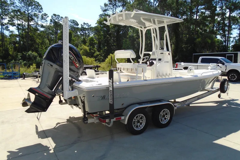 The Image of 2022 Pathfinder 2200 TRS boat on trailer, parked outdoors with trees in background. - 0