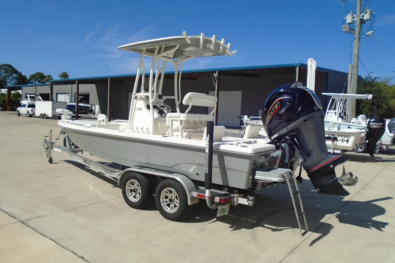 Slide: The Image of 2022 Pathfinder 2200 TRS boat on trailer with Yamaha outboard motor in a parking lot. - 7