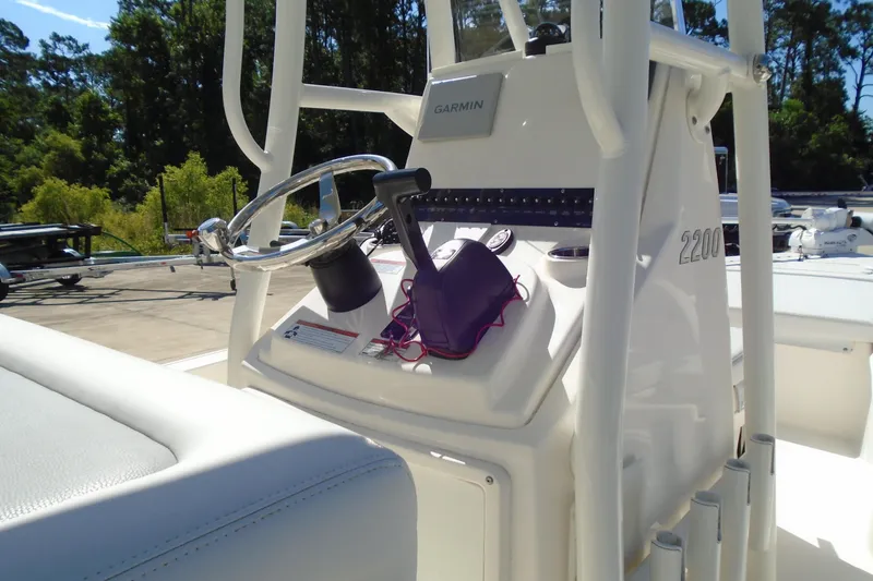 Slide: The Image of 2022 Pathfinder 2200 TRS boat console with Garmin navigation system and steering wheel. - 11