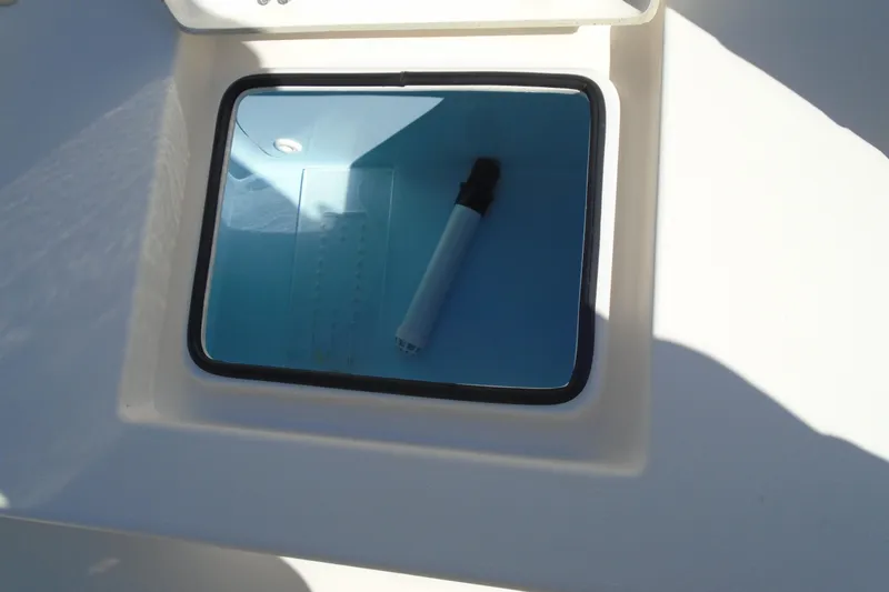 Slide: The Image of Livewell compartment on a 2022 Pathfinder 2200 TRS boat, featuring a blue interior. - 25