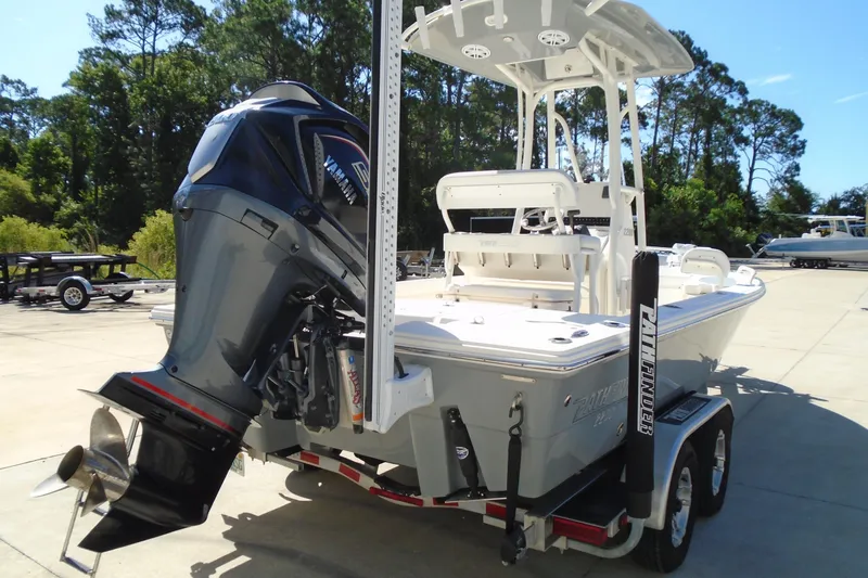 Slide: The Image of 2022 Pathfinder 2200 TRS boat with Yamaha outboard motor on trailer, parked outdoors. - 13