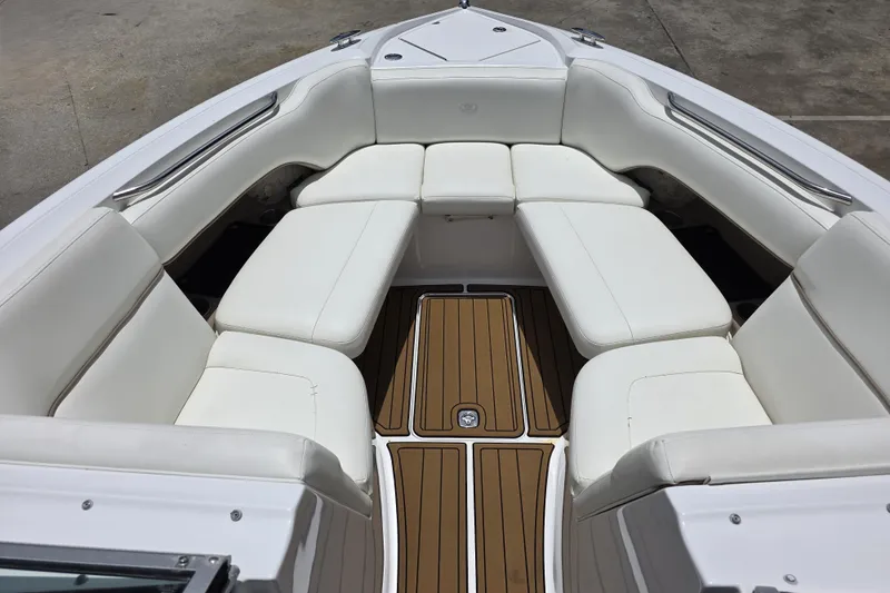 Slide: The Image of Luxurious white seating in a 2006 Cobalt 272 boat with teak-style flooring. - 16