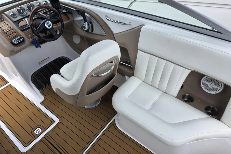 Slide: The Image of Interior of a 2006 Cobalt 272 boat with white seating and wood accents. - 11