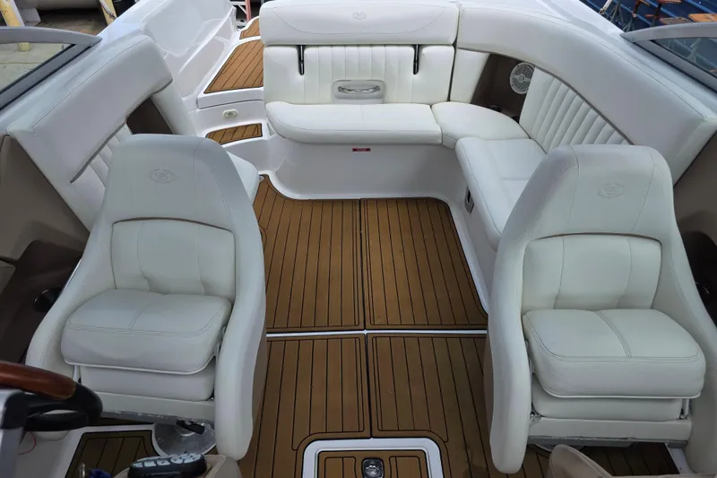 Slide: The Image of Interior of a 2006 Cobalt 272 boat with white seating and wooden flooring. - 20