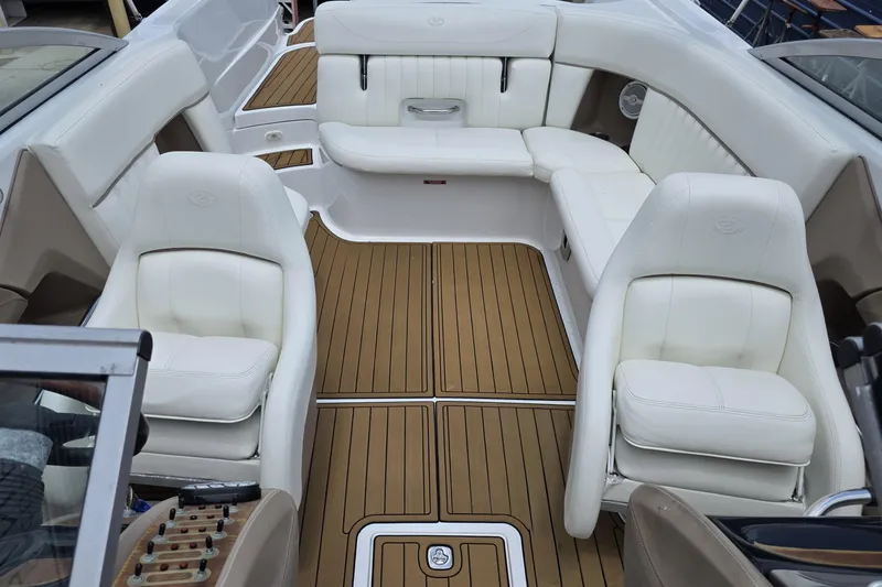 Slide: The Image of Interior of a 2006 Cobalt 272 boat with white seating and wooden flooring. - 19