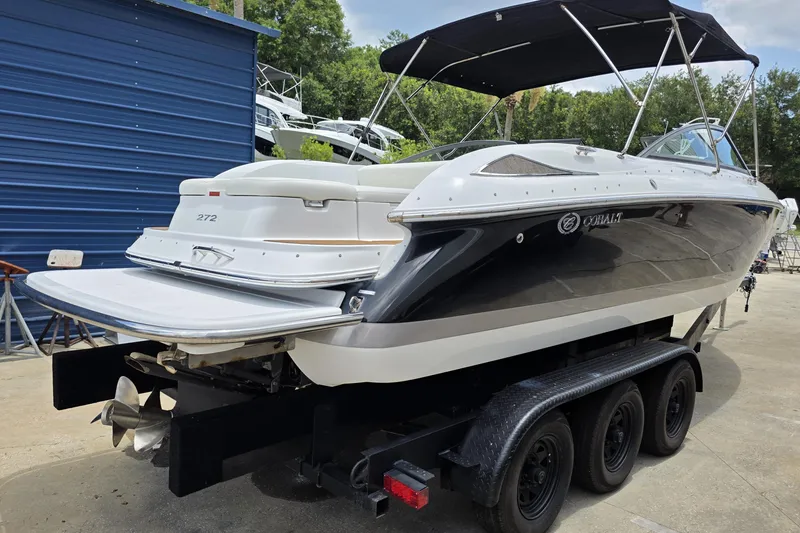 Slide: The Image of 2006 Cobalt 272 boat on a trailer, featuring sleek design and black-and-white color scheme. - 4