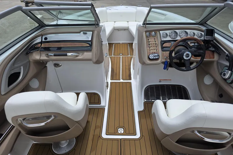 Slide: The Image of Interior of a 2006 Cobalt 272 boat featuring sleek dashboard and comfortable seating. - 10